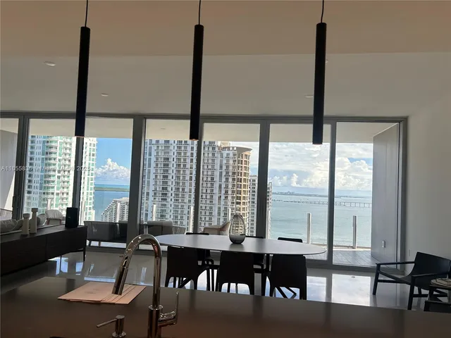 a kitchen with stainless steel appliances a sink a stove and a large window