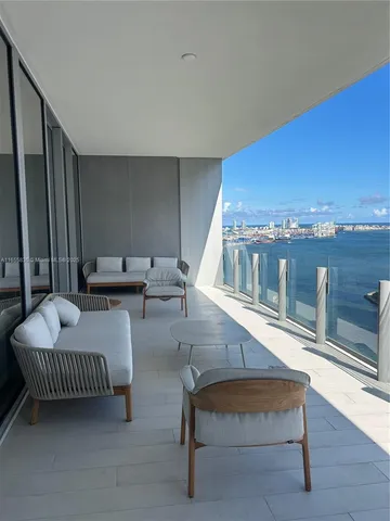 a view of a city from a dining room with furniture