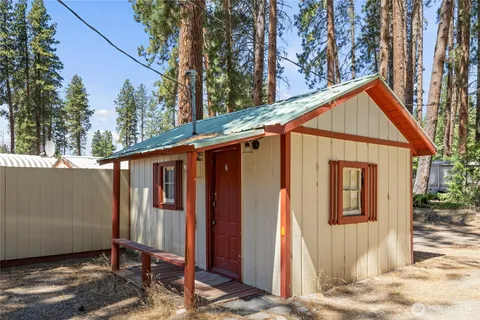 a view of a house with a porch and furniture