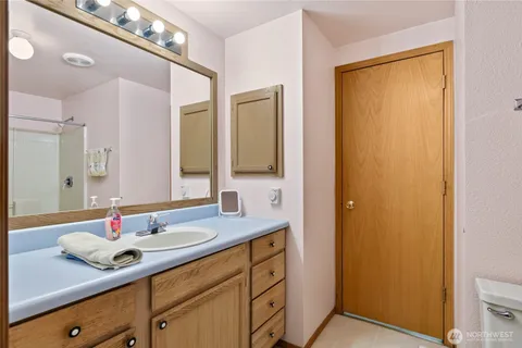 a view of bathroom with a sink and mirror