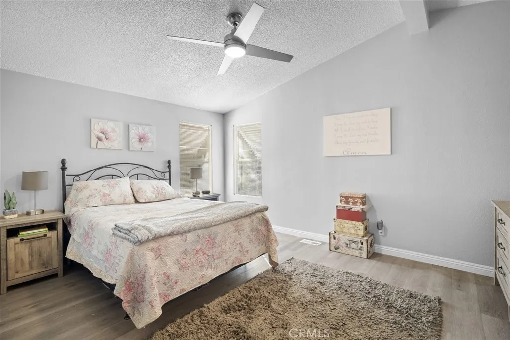 27701 Murrieta Road, Unit 37 Menifee, CA 92586 - Photo 11 of 24 a bedroom with a bed and a chandelier