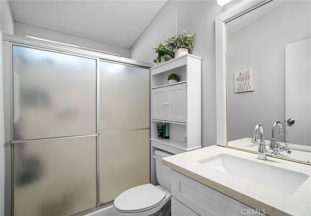 27701 Murrieta Road, Unit 37 Menifee, CA 92586 - Photo 15 of 24 a bathroom with a sink toilet and shower