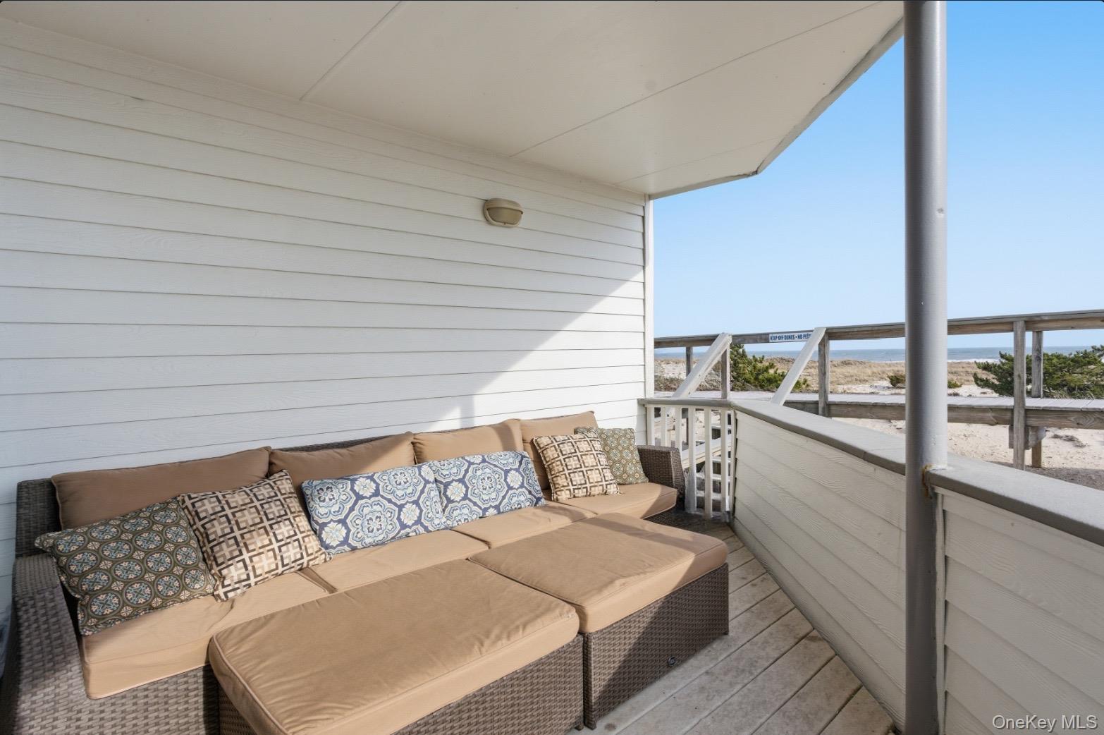 253 Dune Road, Unit 49 Westhampton Beach, NY 11978 - Photo 19 of 31 a balcony with furniture and view of balcony
