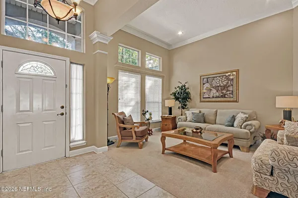 a living room with furniture and a large window