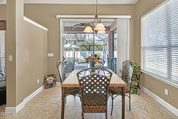 a view of a dining room with furniture wooden floor and chandelier