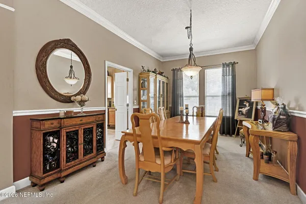 a view of a dining room with furniture window and flowerpot