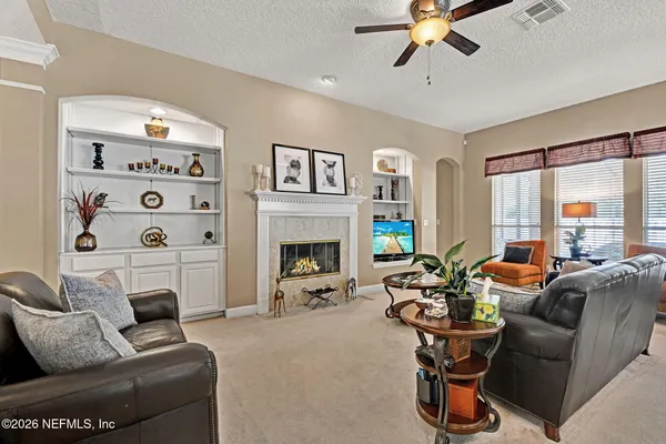 a living room with furniture fireplace and window