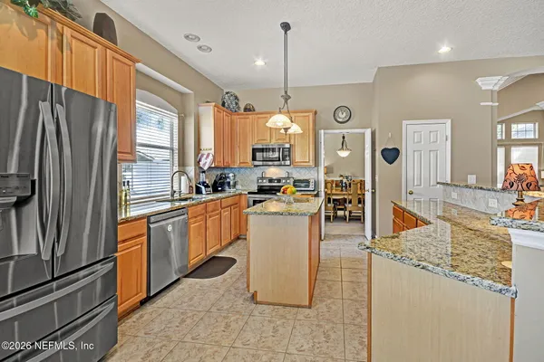 a kitchen with refrigerator and window