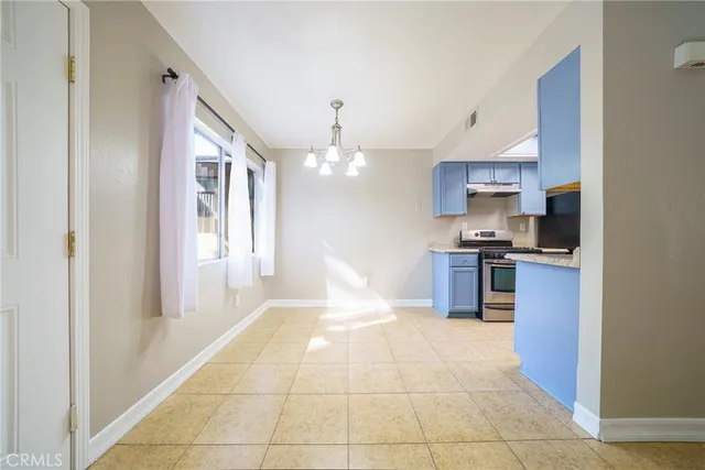 a view of kitchen with sink and refrigerator