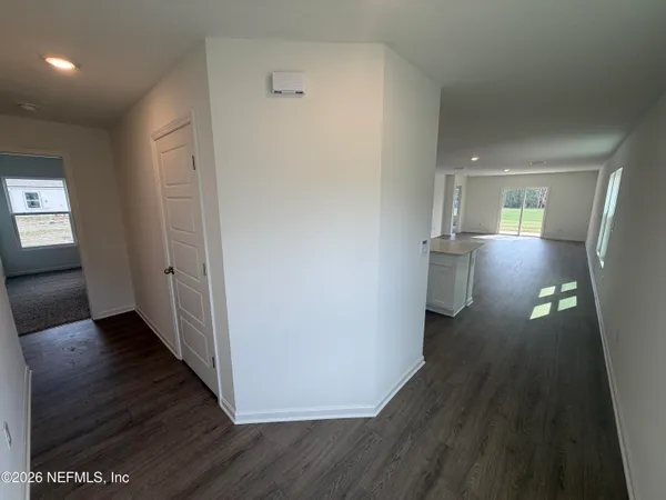 a kitchen with stainless steel appliances a dining table chairs and wooden floor