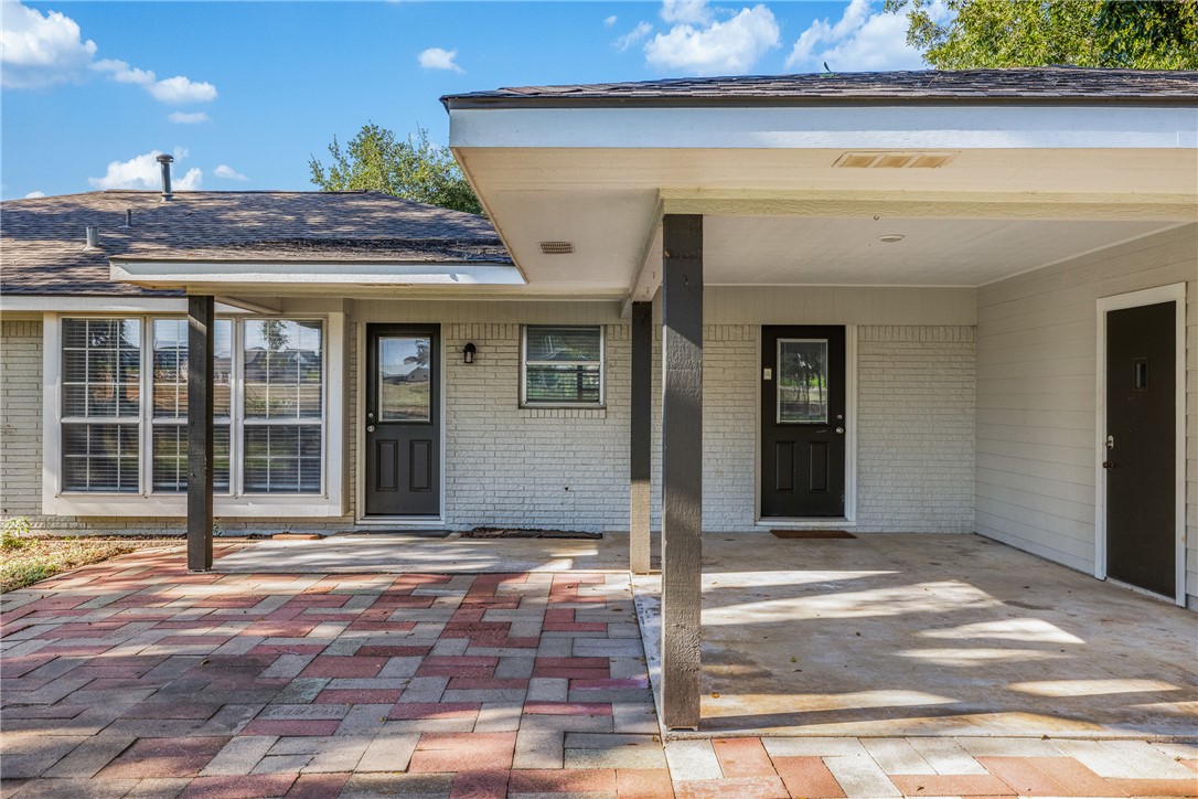 1906 Gun And Rod Road Brenham, TX 77833 - Photo 11 of 30 Doorway to property featuring a patio area and brick siding