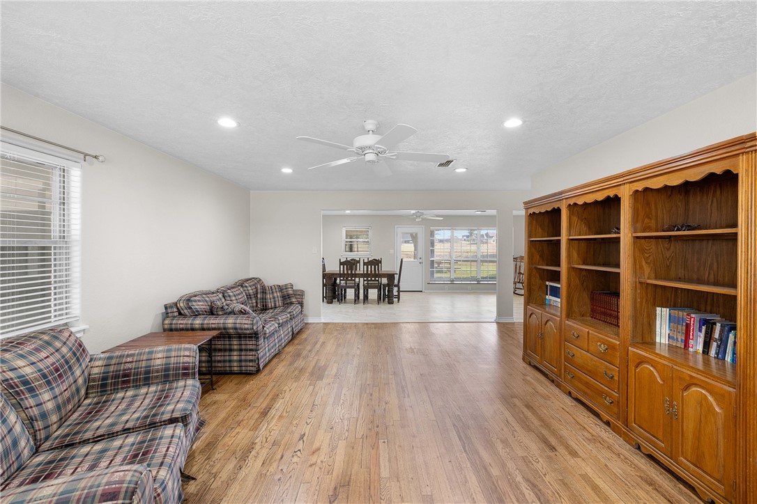 1906 Gun And Rod Road Brenham, TX 77833 - Photo 14 of 30 Living room with light wood-style floors, recessed lighting, a textured ceiling, and ceiling fan