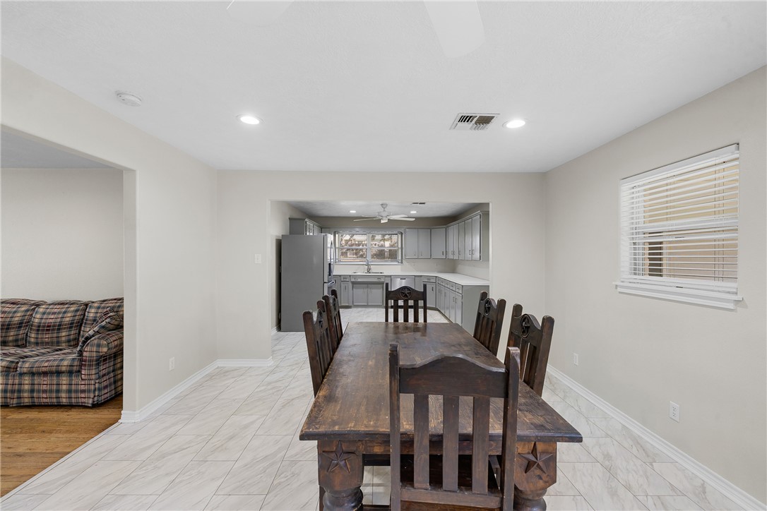 1906 Gun And Rod Road Brenham, TX 77833 - Photo 16 of 30 Dining room with recessed lighting, light marble finish flooring, and a ceiling fan