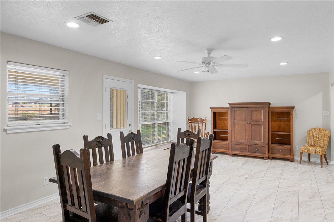 1906 Gun And Rod Road Brenham, TX 77833 - Photo 19 of 30 Dining space with recessed lighting, a ceiling fan, and a textured ceiling