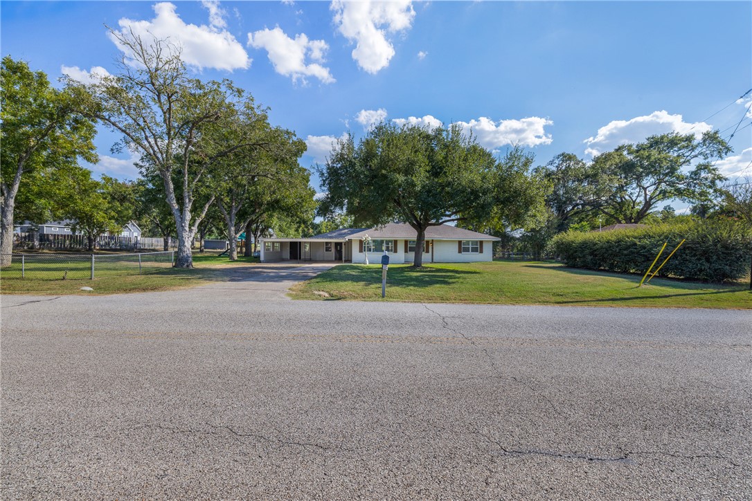 1906 Gun And Rod Road Brenham, TX 77833 - Photo 2 of 30 Ranch-style home featuring asphalt driveway and a carport
