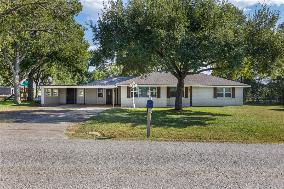 1906 Gun And Rod Road Brenham, TX 77833 - Photo 3 of 30 Single story home with a front yard, driveway, and brick siding