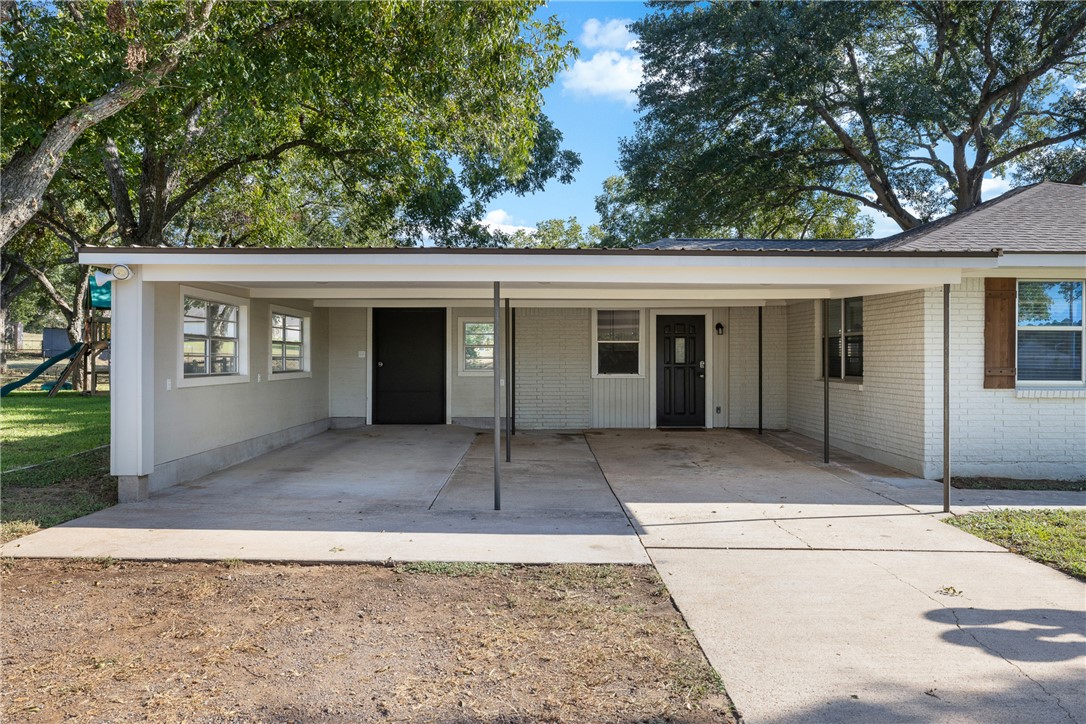 1906 Gun And Rod Road Brenham, TX 77833 - Photo 6 of 30 Single story home with a playground, brick siding, a carport, and driveway
