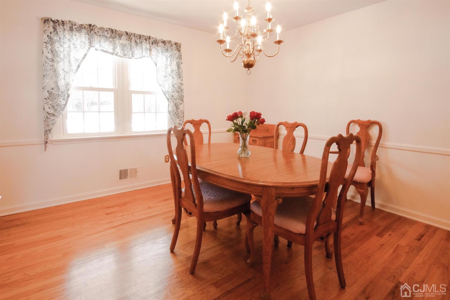 7 Markus Drive Kendall Park, NJ 08824 - Photo 22 of 47 a dining room with furniture a chandelier and wooden floor