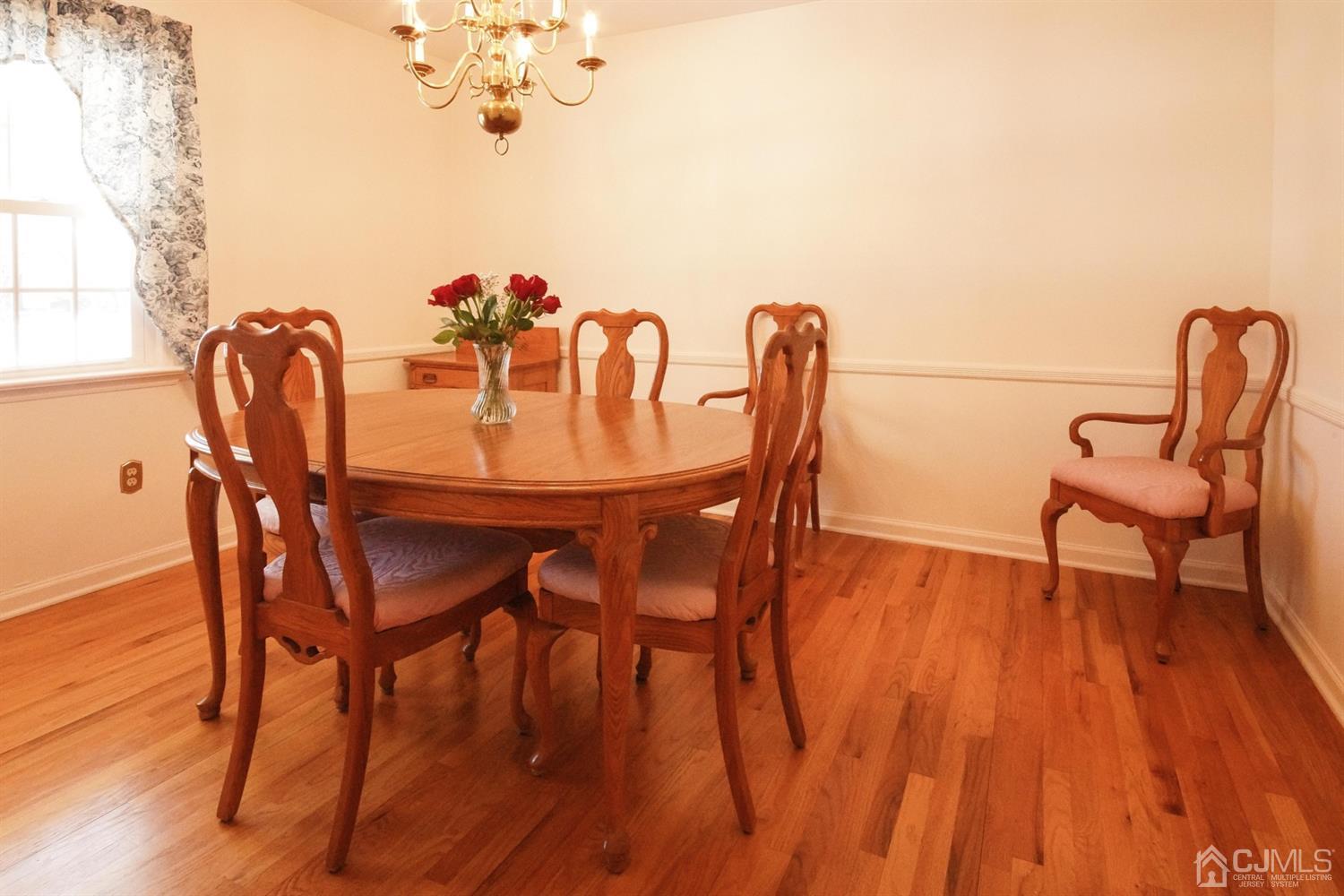 7 Markus Drive Kendall Park, NJ 08824 - Photo 23 of 47 a dining room with furniture and wooden floor
