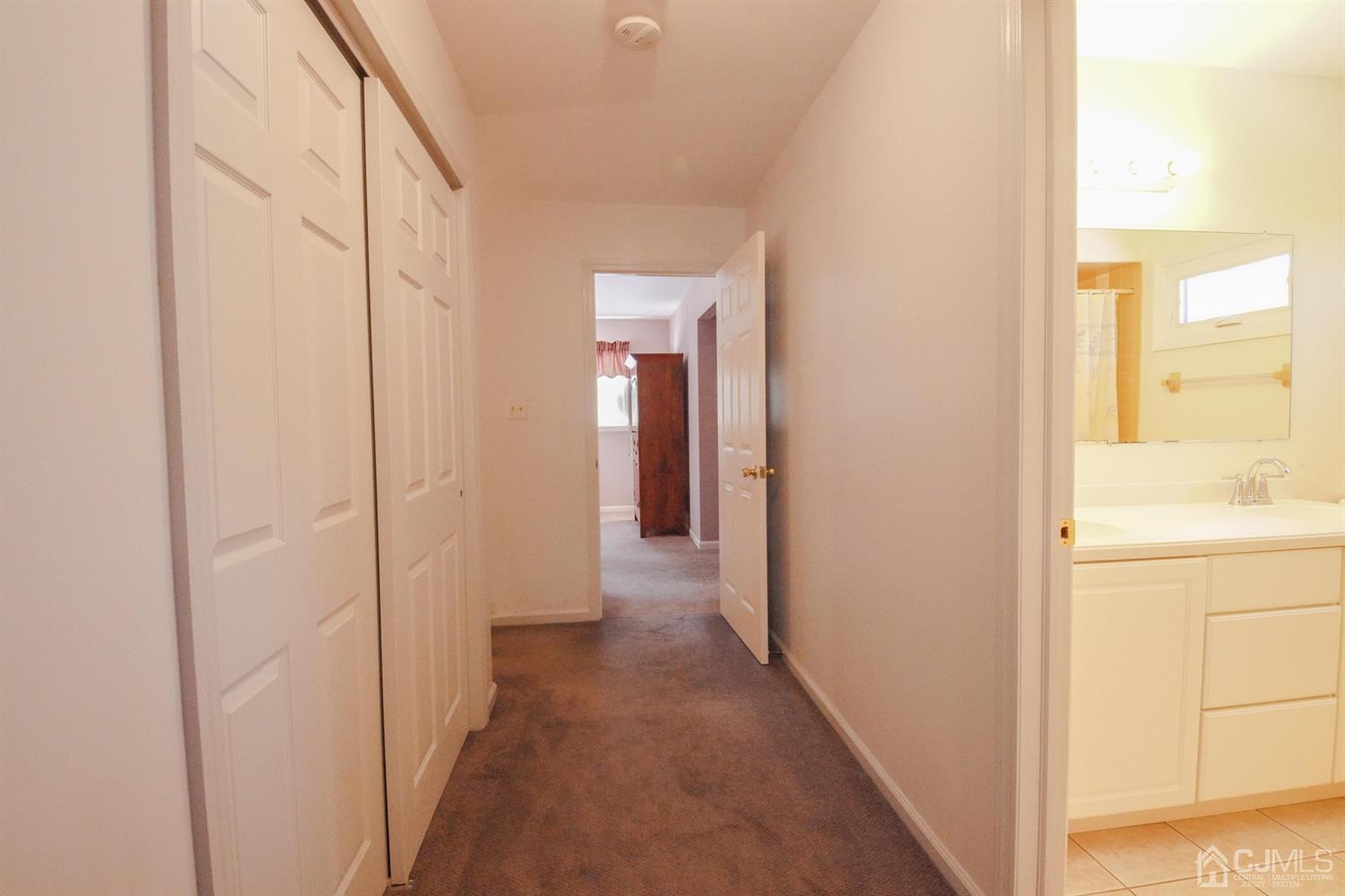 7 Markus Drive Kendall Park, NJ 08824 - Photo 30 of 47 a view of a bathroom from a hallway