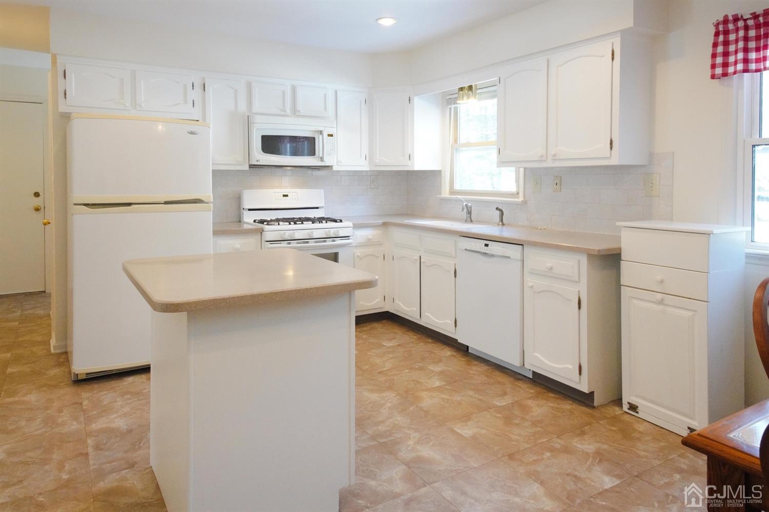 7 Markus Drive Kendall Park, NJ 08824 - Photo 34 of 47 a kitchen with granite countertop white cabinets and refrigerator