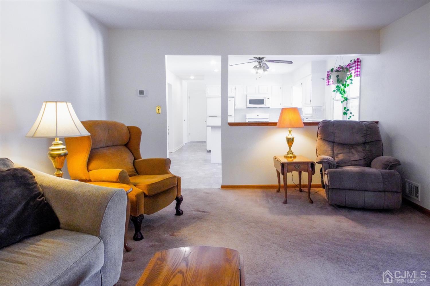 7 Markus Drive Kendall Park, NJ 08824 - Photo 39 of 47 a living room with furniture and a lamp