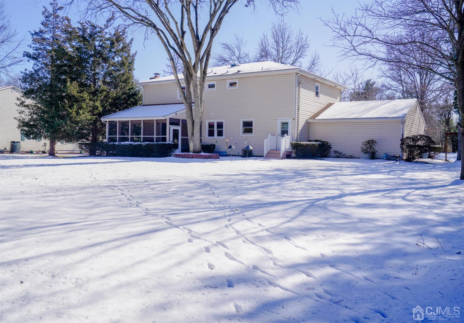 7 Markus Drive Kendall Park, NJ 08824 - Photo 10 of 47 a view of a white house with a large tree and a yard