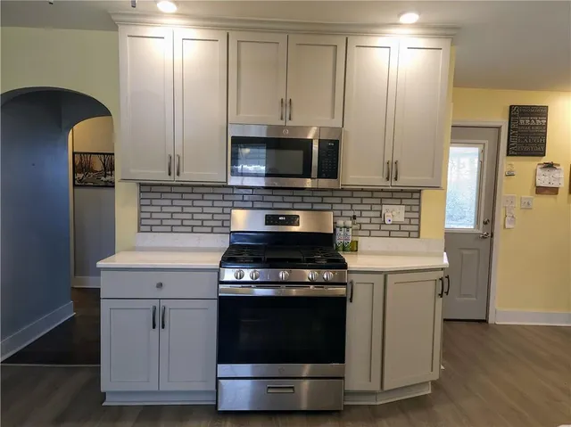 a kitchen with a stove and a microwave