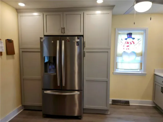 a view of a refrigerator in kitchen and wooden floor