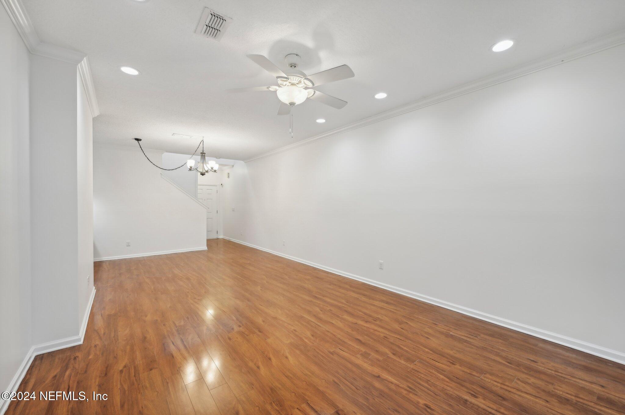 165 Amistad Drive St. Augustine, FL 32086 - Photo 13 of 41 a view of an empty room with wooden floor