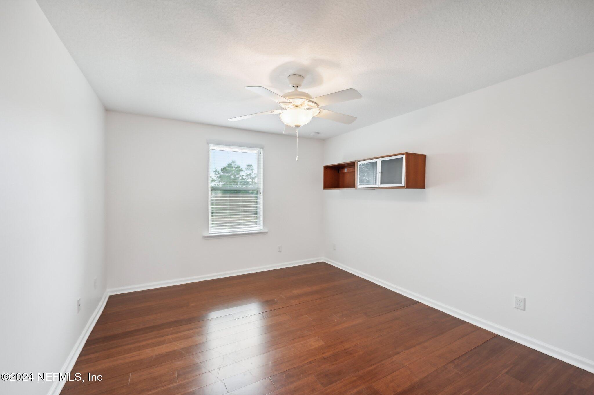 165 Amistad Drive St. Augustine, FL 32086 - Photo 29 of 41 a view of a big room with wooden floor and a ceiling fan