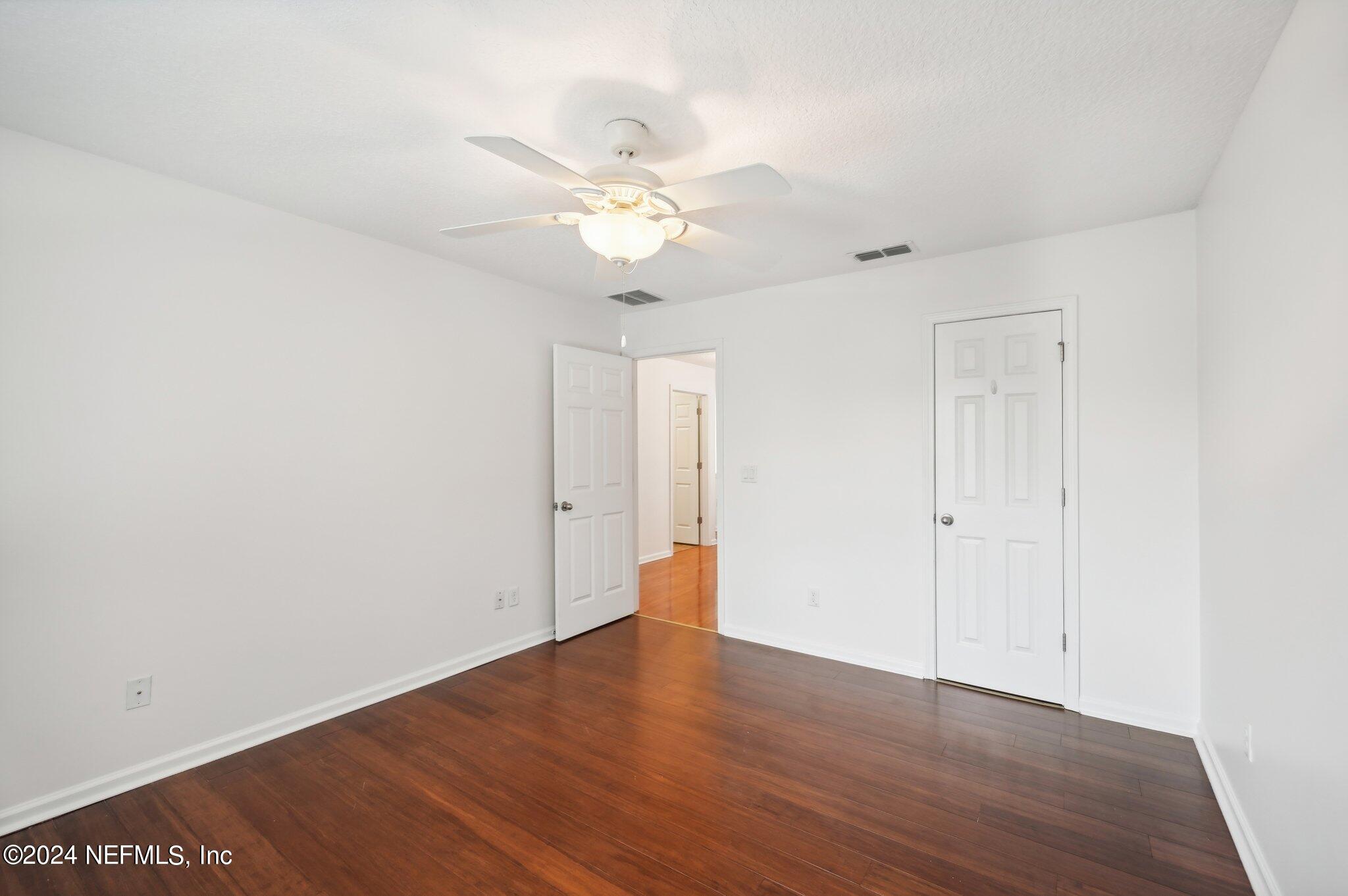 165 Amistad Drive St. Augustine, FL 32086 - Photo 33 of 41 a view of an empty room with wooden floor
