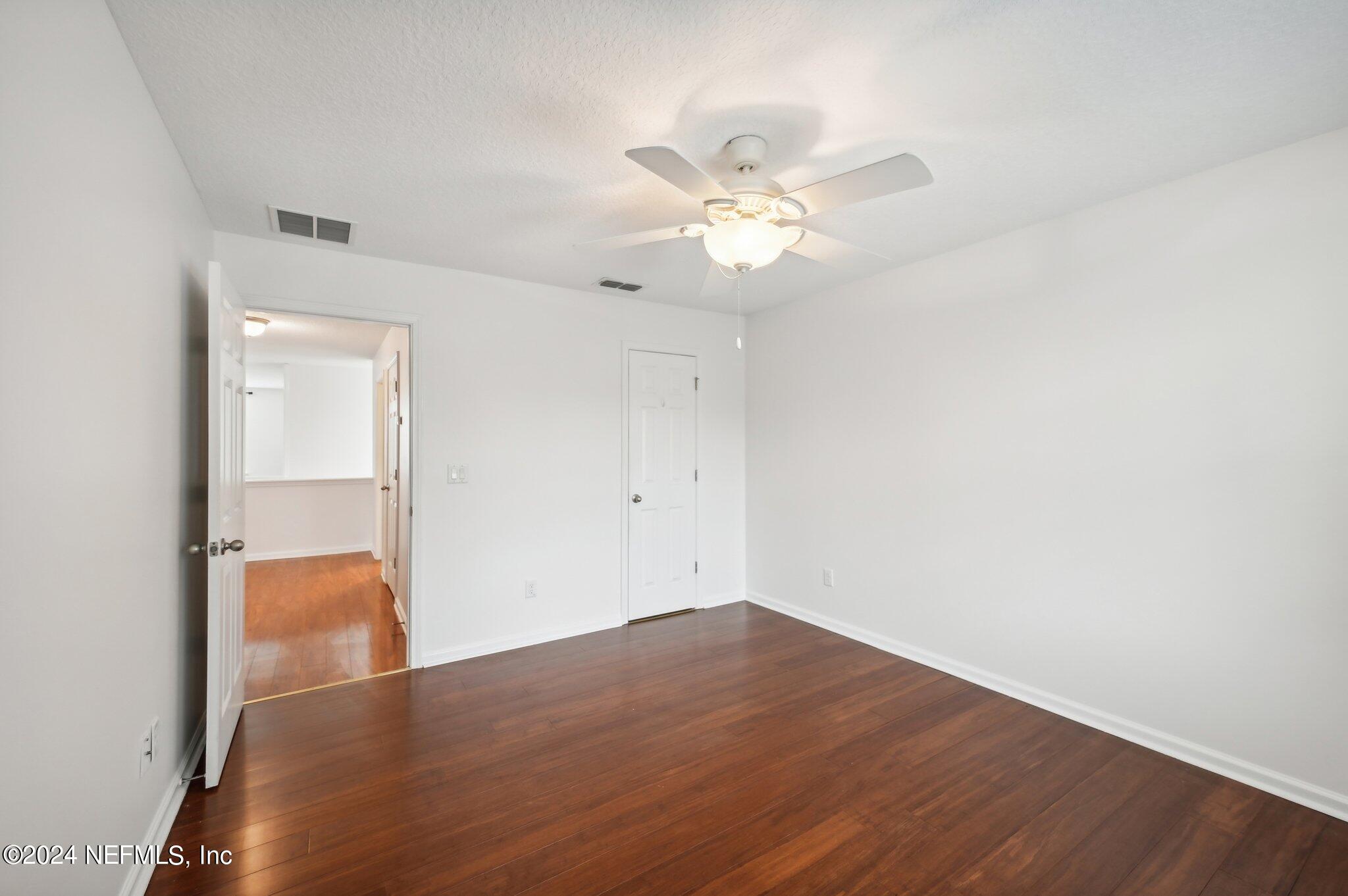 165 Amistad Drive St. Augustine, FL 32086 - Photo 34 of 41 an empty room with wooden floor and ceiling fan