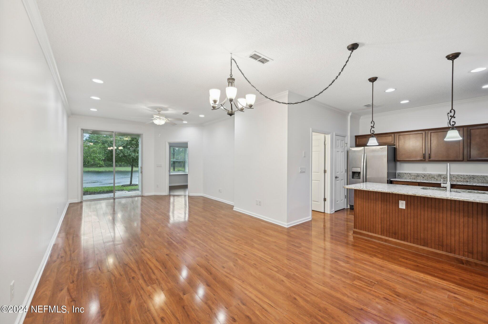 165 Amistad Drive St. Augustine, FL 32086 - Photo 5 of 41 a view of a kitchen with a sink wooden floor and a large window
