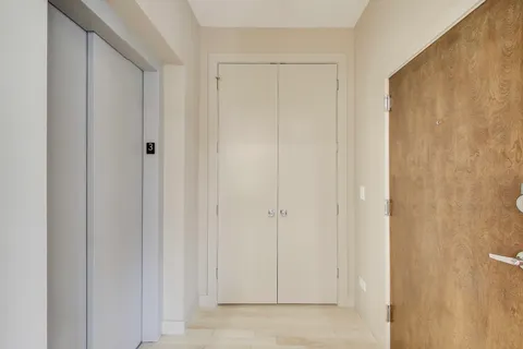a balcony with furniture and a potted plant