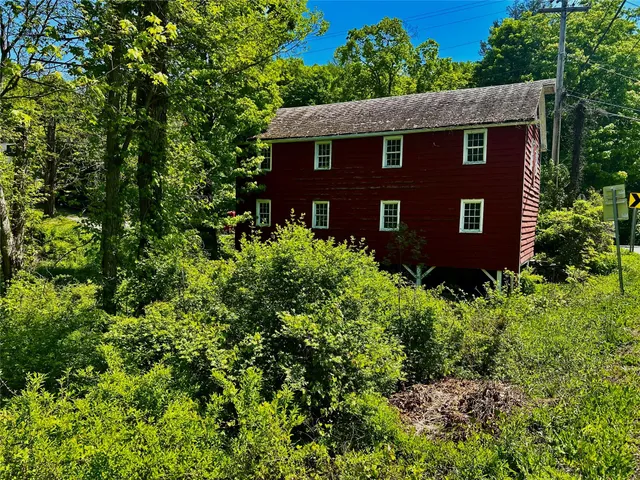 a view of a brick house with a small yard