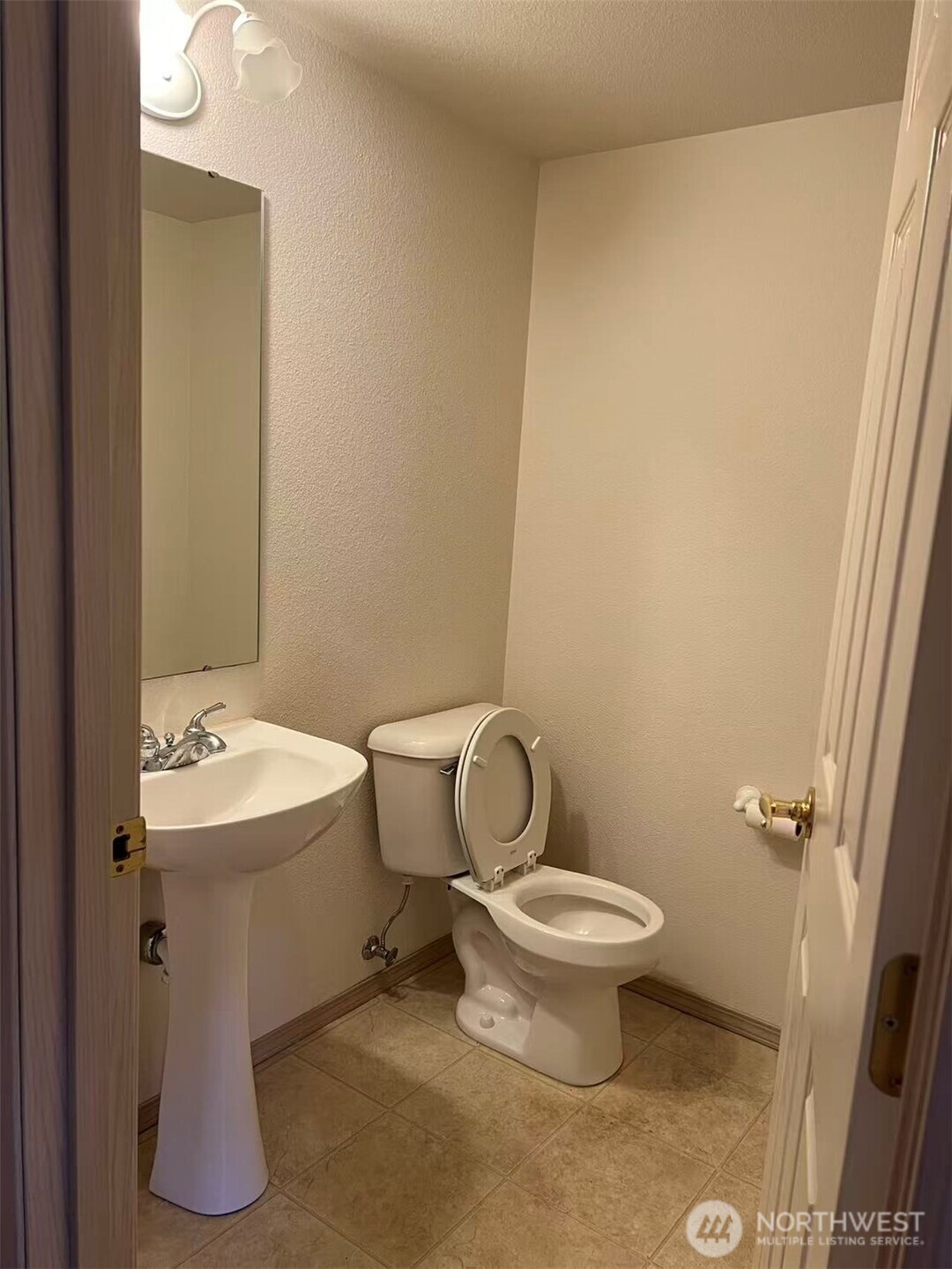 1160 Monroe Avenue Northeast, Unit D2 Renton, WA 98056 - Photo 8 of 16 a white toilet sitting next to a bathroom sink