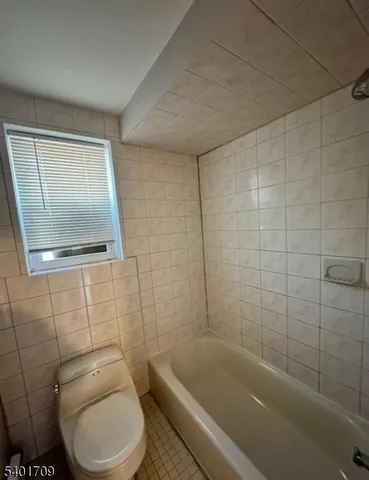 a bathroom with a toilet a sink and bathtub