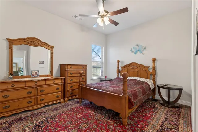 a bedroom with a bed and a dresser in it