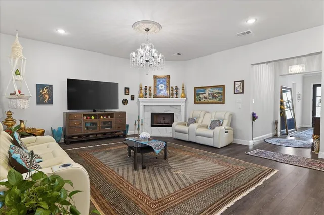 a living room with furniture a fireplace and a flat screen tv