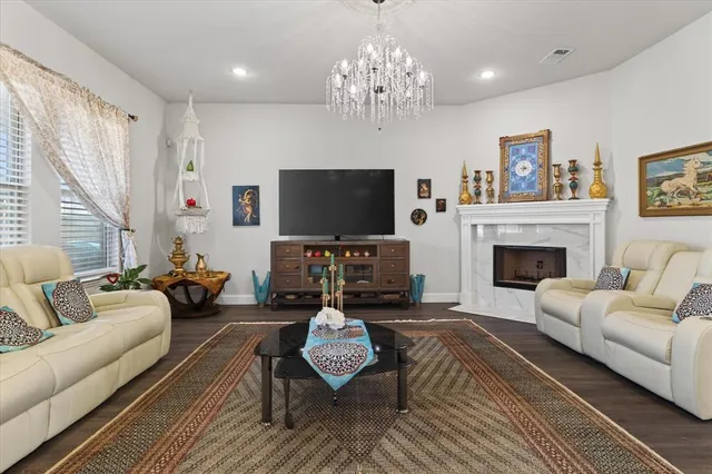 a living room with furniture a fireplace and a flat screen tv