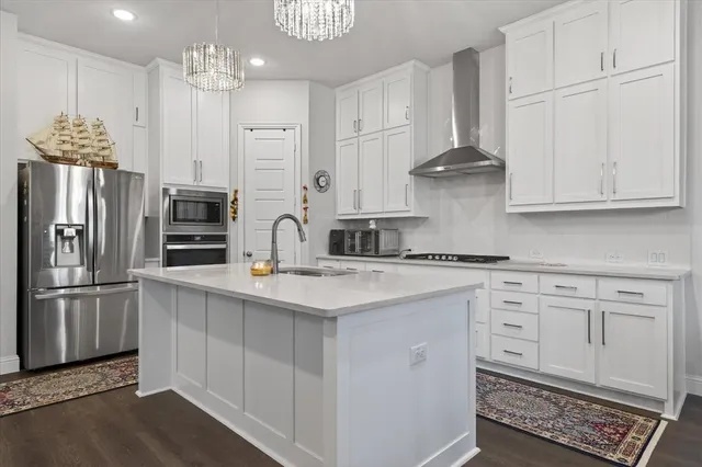 a kitchen with stainless steel appliances granite countertop a refrigerator sink and cabinets