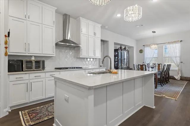 a kitchen with stainless steel appliances granite countertop a sink and cabinets