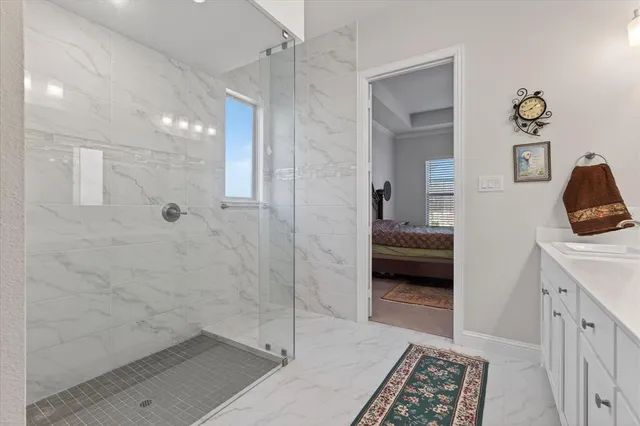 a en suite bathroom with a sink a mirror and a shower