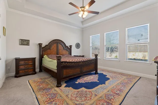 a bedroom with a bed rug and dresser