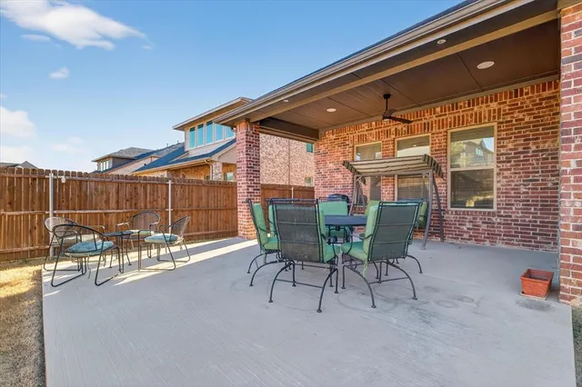 a patio with table and chairs