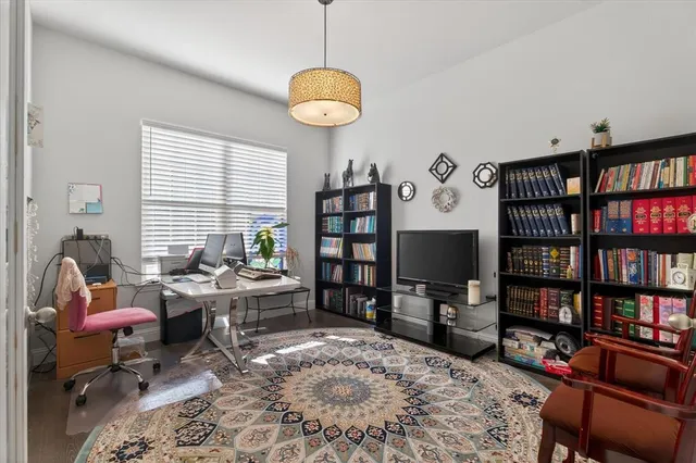 a living room with furniture a rug and a book shelf