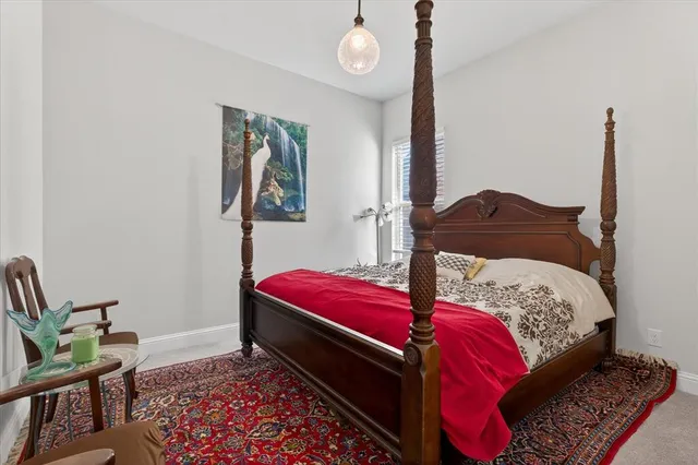 a bedroom with a bed and a potted plant