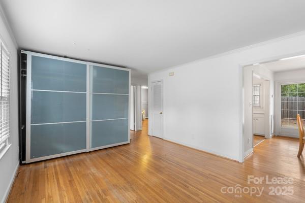 918 McAlway Road, Unit B Charlotte, NC 28211 - Photo 1 of 19 a view of an empty room with wooden floor and a window