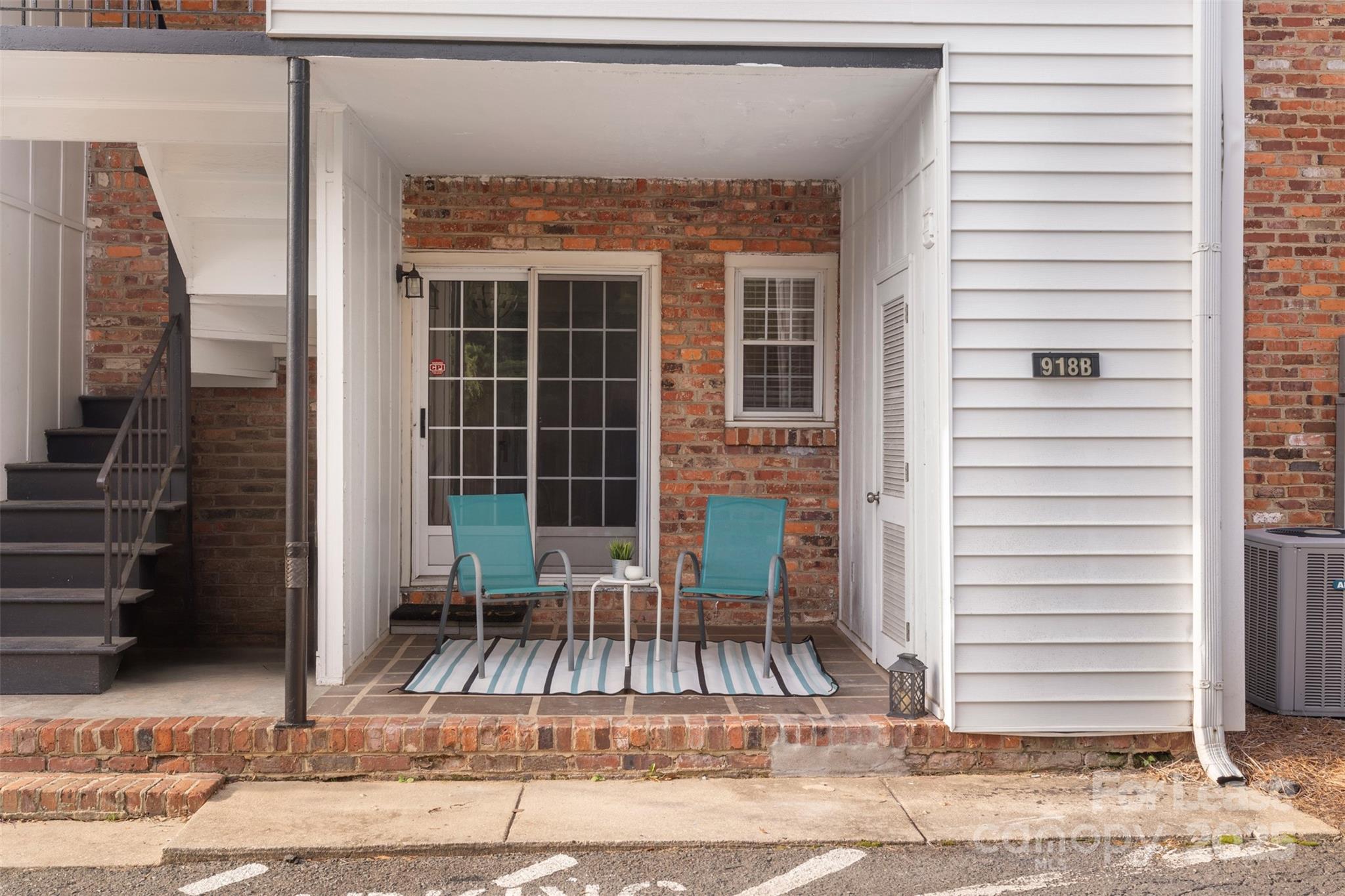 a view of a patio with a table and chairs and potted plants